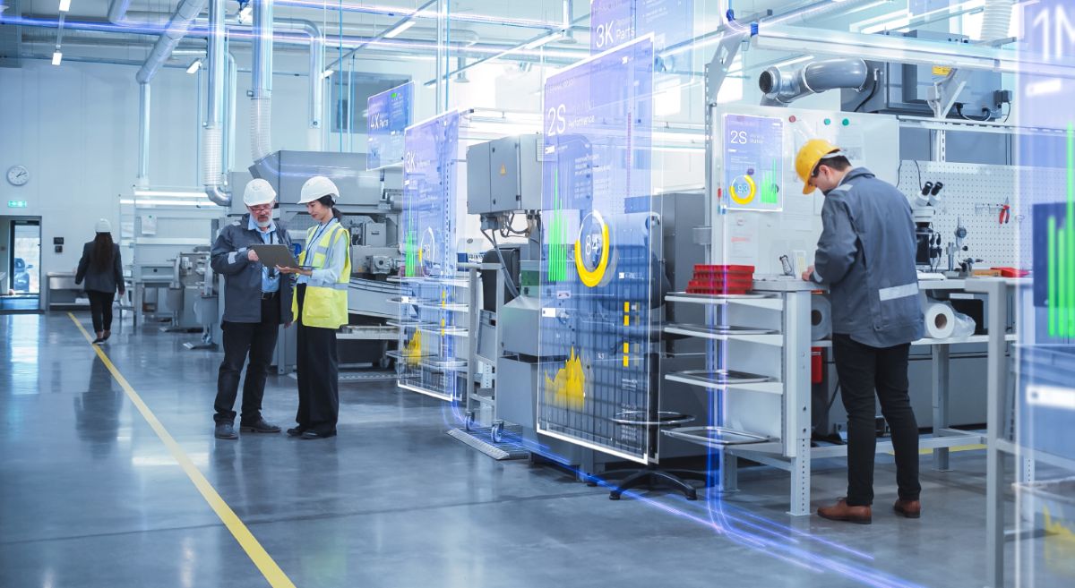 Inside a state of the art industrial facility with male and female workers in hard hats